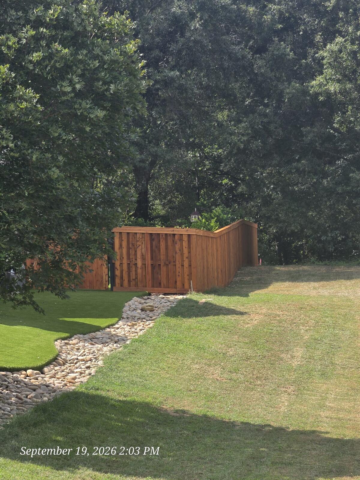 Finished stained cedar privacy fence with cap and trim Monroe NC