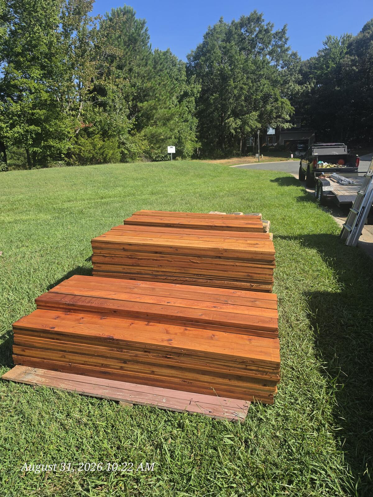 Pre-stained Western red cedar fence pickets staged for installation